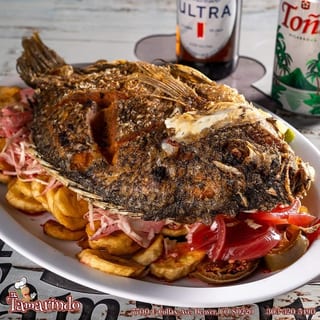 Fried tilapia with banana chips - Mojarra con tajada
